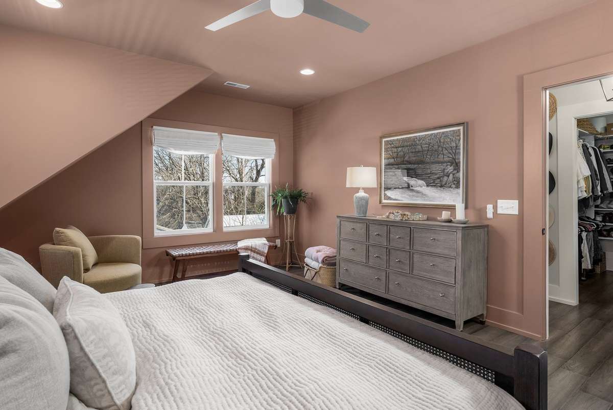 Just beyond the sanctuary of the bed, a quiet sitting area offers a private place to read, reflect, or begin the morning slowly.