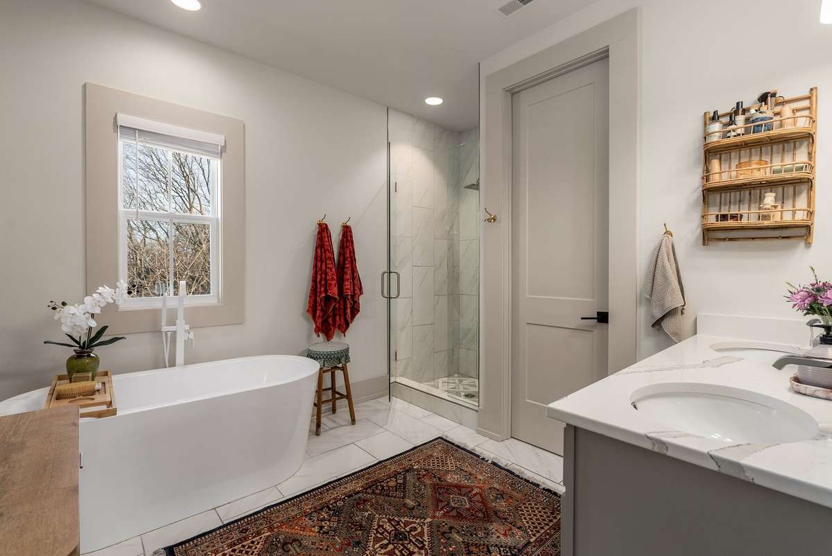 A spa-inspired bath complete with a soaking tub, glass-enclosed shower, and timeless finishes—thoughtfully designed for relaxation and renewal.