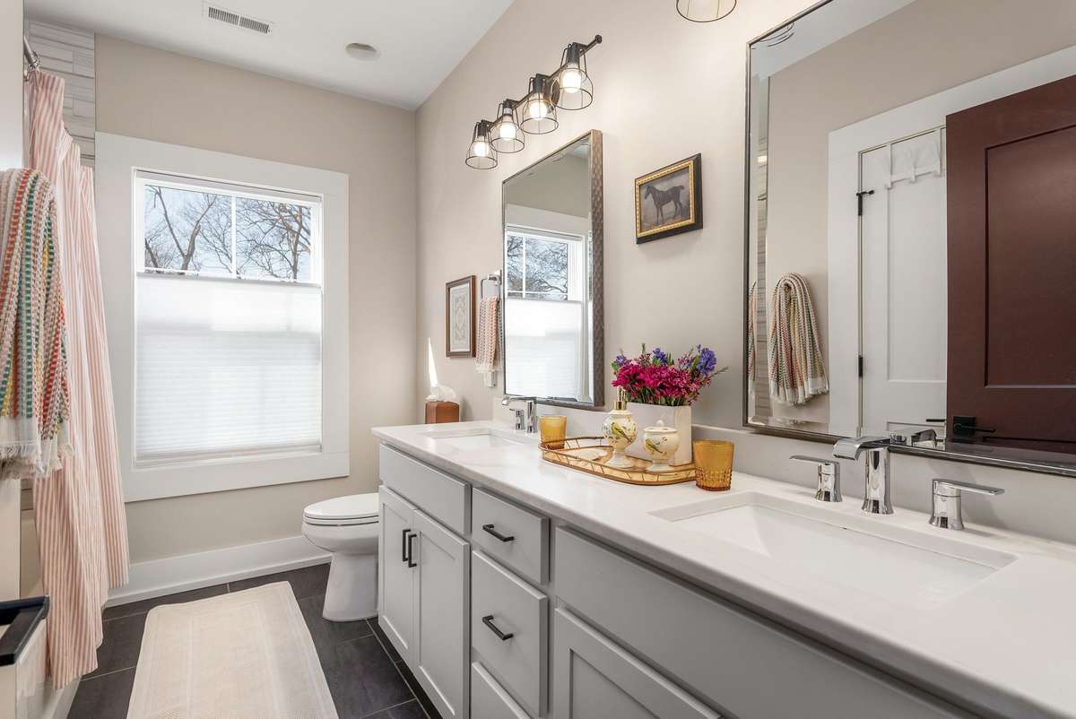 Bright and beautifully arranged, the double vanity offers generous counter space and storage—making busy mornings feel streamlined and organized.
