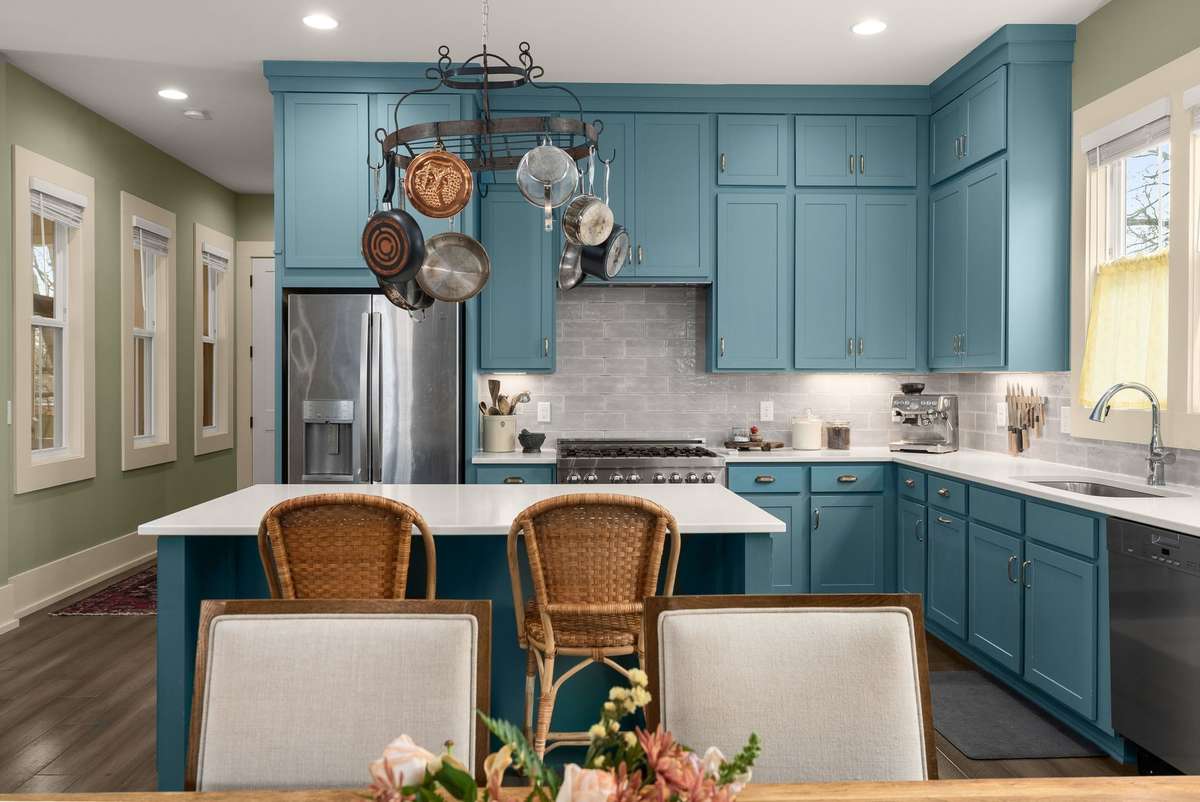 Rich cabinetry, an oversized island, and thoughtful details create a kitchen that invites you to slow down—cook, gather, and enjoy the art of home.
