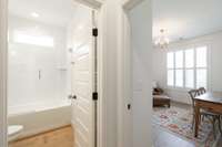 The adjoining bath features a fully tiled shower with an upgraded glass door, combining style and function. High-end finishes make it a perfect complement to the main-level guest suite.