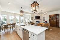 The kitchen boasts a walk-in pantry with solid wood shelving, elegant soft-close cabinets and drawers, and a stylish tile backsplash for a refined and functional space.