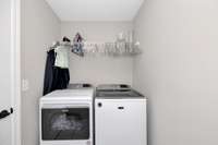 Laundry Room- Tile flooring, wire shelving, washer/dryer hookups