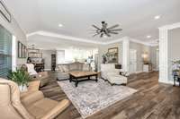 Living Room- LVP flooring, crown molding, recessed lighting, ceiling fan, 10' ceiling