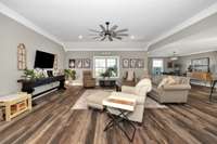 Living Room- LVP flooring, crown molding, recessed lighting, ceiling fan, 10' ceiling