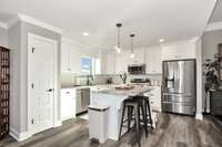 Kitchen- LVP flooring, kitchen island, tile backsplash, recessed lighting, crown molding, pantry, stainless steel appliances- refrigerator, microwave, stove/oven, dishwasher