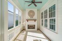 Enjoy a second gas burning fireplace on your screen patio, characterized by custom painted ceiling, and wood mantle with TV mounting setup in place.