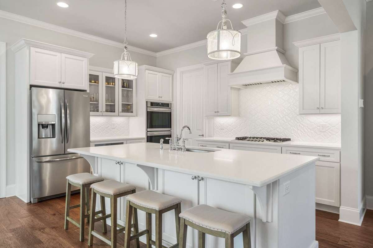 Complimented with staggered cabinets, under cabinet lighting, and glass paneled front upper cabinets - the kitchen is well appointed.