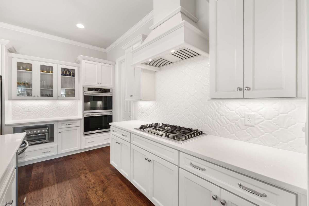 Kitchen tile backsplash and pantry entry door shown here