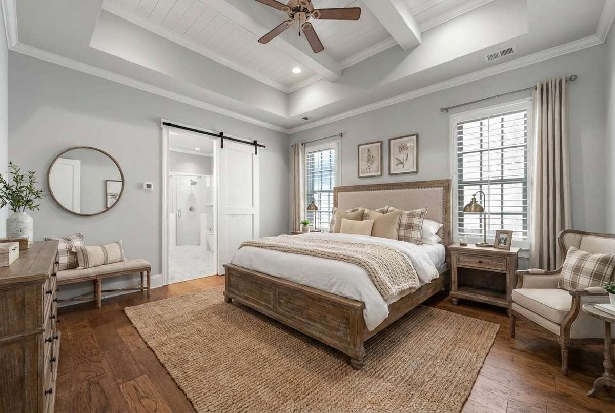 Virtually staged main floor primary bedroom - a room large enough for a few seating options!
