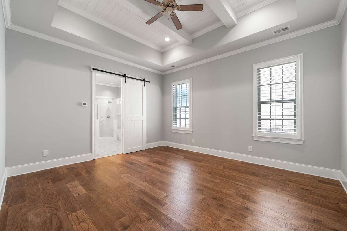 Alternate view of the primary suite with private bath access, and double windows (also with plantation shutters)