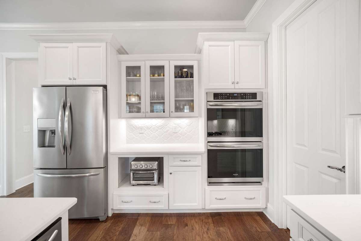Charming cabinet setup offers glass fronts on select uppers