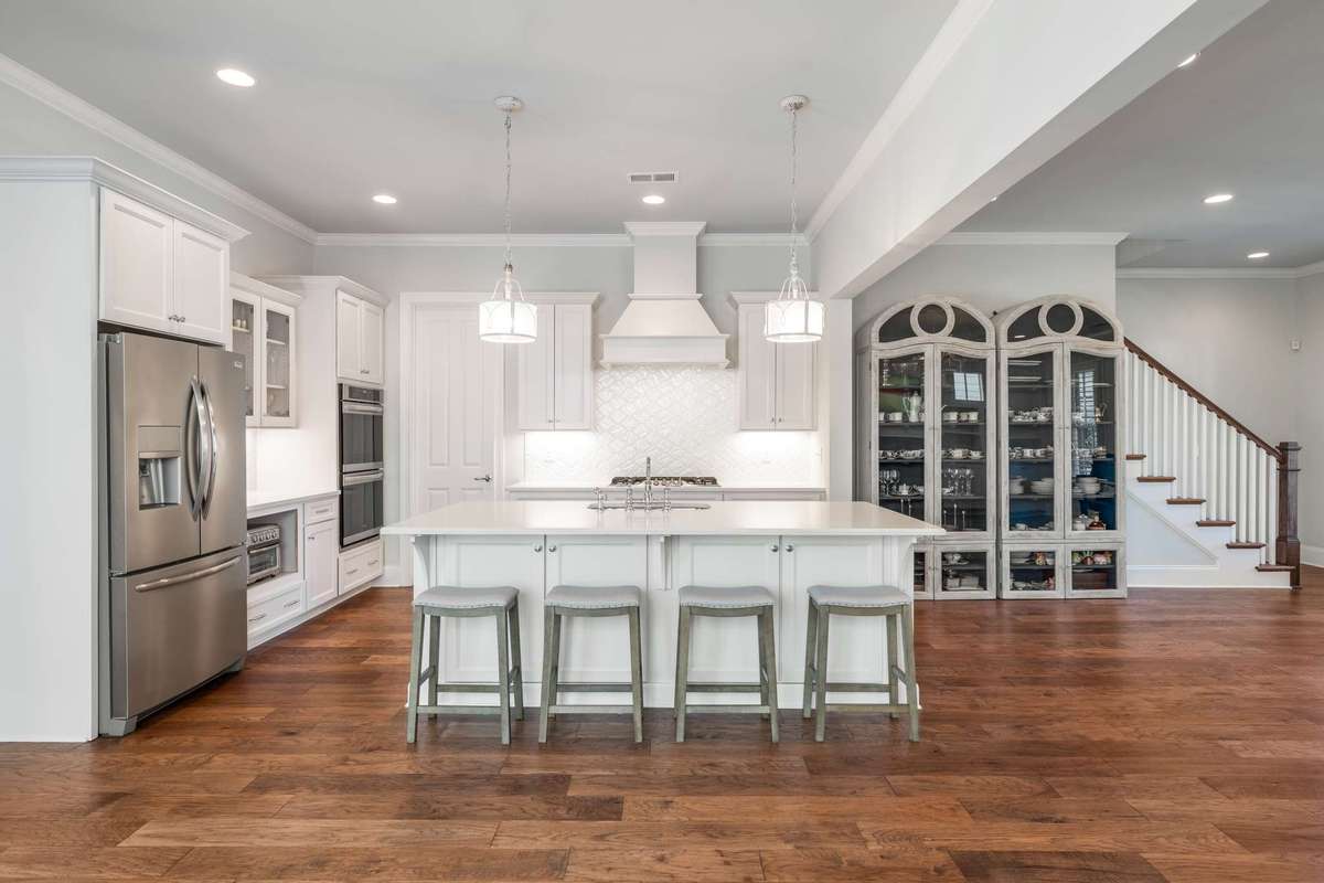 The large kitchen island, with informal dining seating, also has dual storage sides and provides a central point to the main living areas to gather around