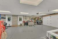 Two smaller vehicles can fit in the garage. These doors take you to the outdoor living areas.