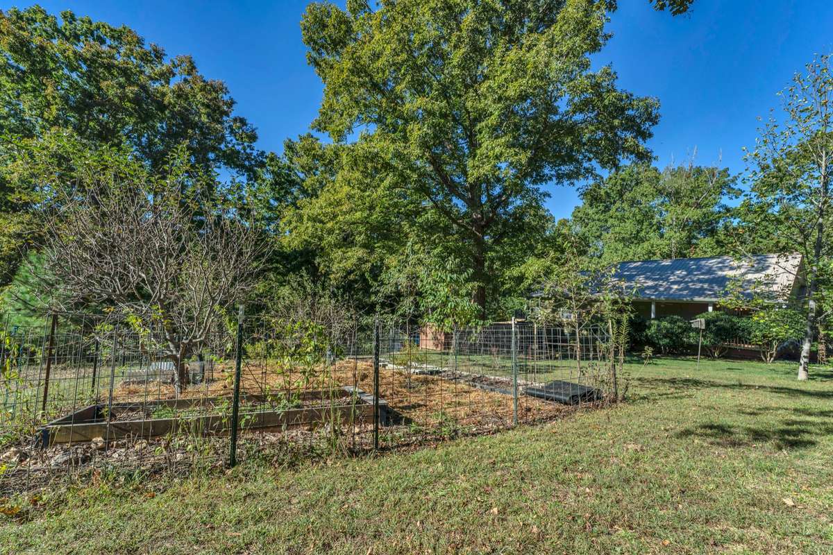 This dog run is on the left side of the home and adjacent to the additional lot for sale.