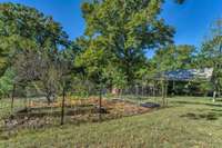 This dog run is on the left side of the home and adjacent to the additional lot for sale.