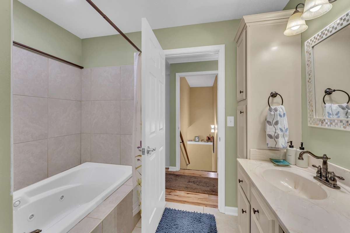 You will appreciate the jetted tub / shower combination with a tile surround.