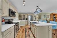 The kitchen has a functional design with plenty of counter space and cabinets.