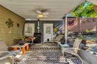 This covered patio is just off the garage. A peaceful water feature is to the right of the patio.