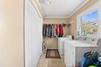 Utility room with tile floors plus extra closet space.