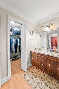 Primary bedroom bath with double sink and walk in closet.