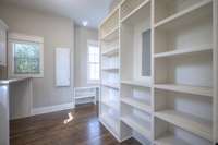 Custom primary closet with laundry room