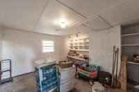 Storage room with shelving and it does have a vent for climate control.