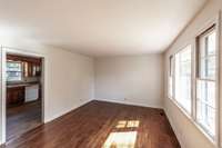 Nice-sized formal living room with a large viewing window for natural light.
