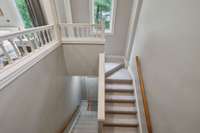 This separate staircase leads to the garage and side of the house.  This is not the main staircase leading downstairs to the finished area.  This is the location where an elevator could be added.