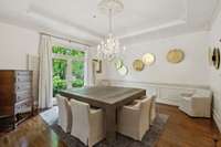 Talk about elevated dining!  This spacious room with its trey ceiling and wainscoting offers picturesque views of the sprawling front lawn.