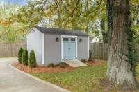Out back you'll find a darling storage shed that matches the house
