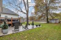The back yard offers ample space with a concrete patio in addition to the deck