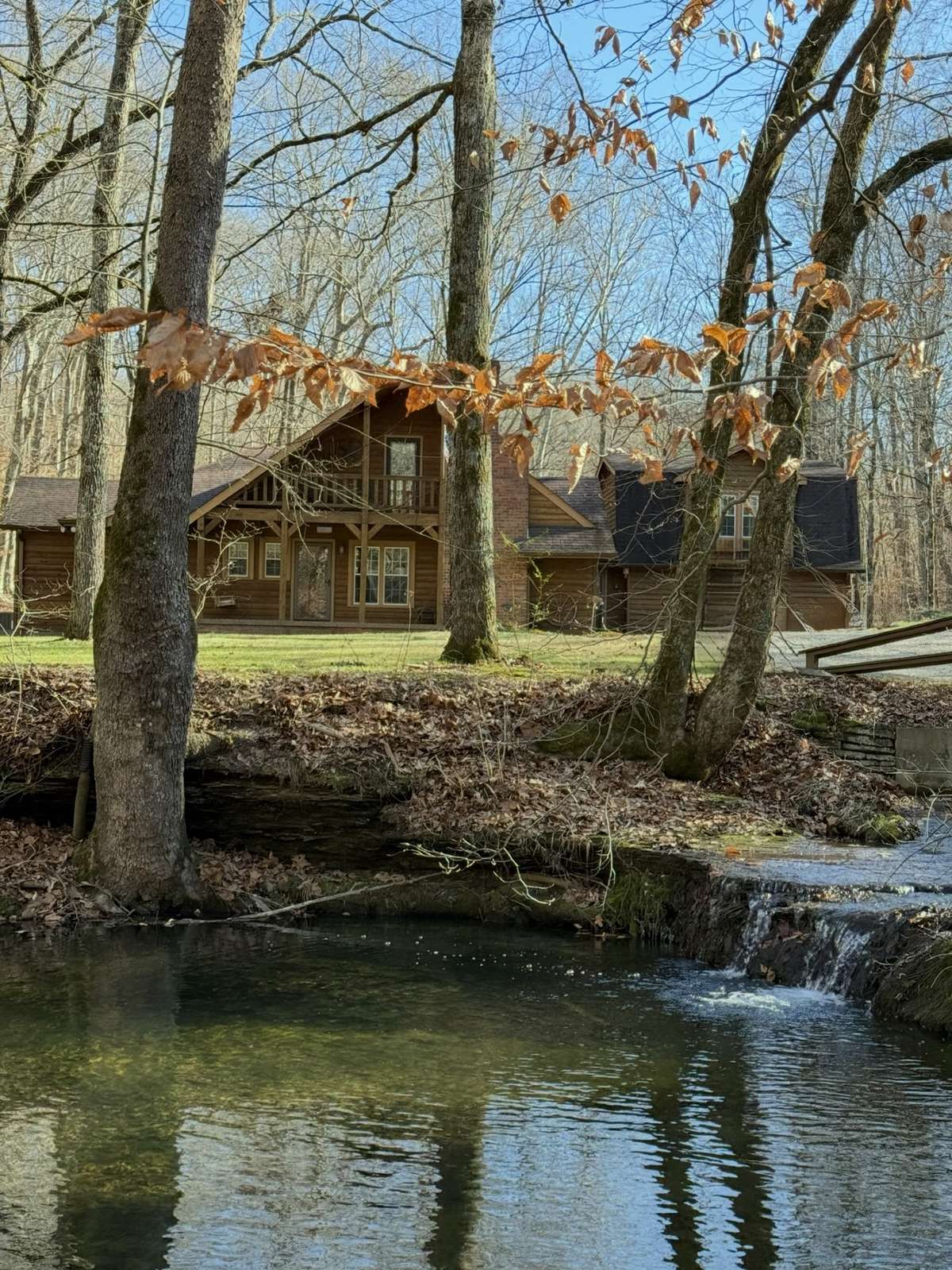 Home in background - Waterfall, creek in front of home.