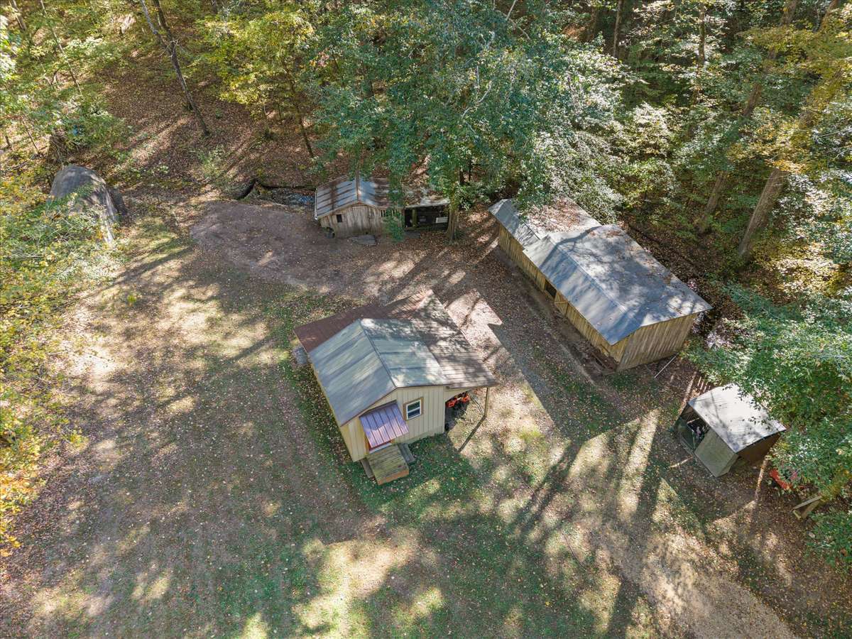 Back of lot with workshop, 3 stall barn, chicken coop