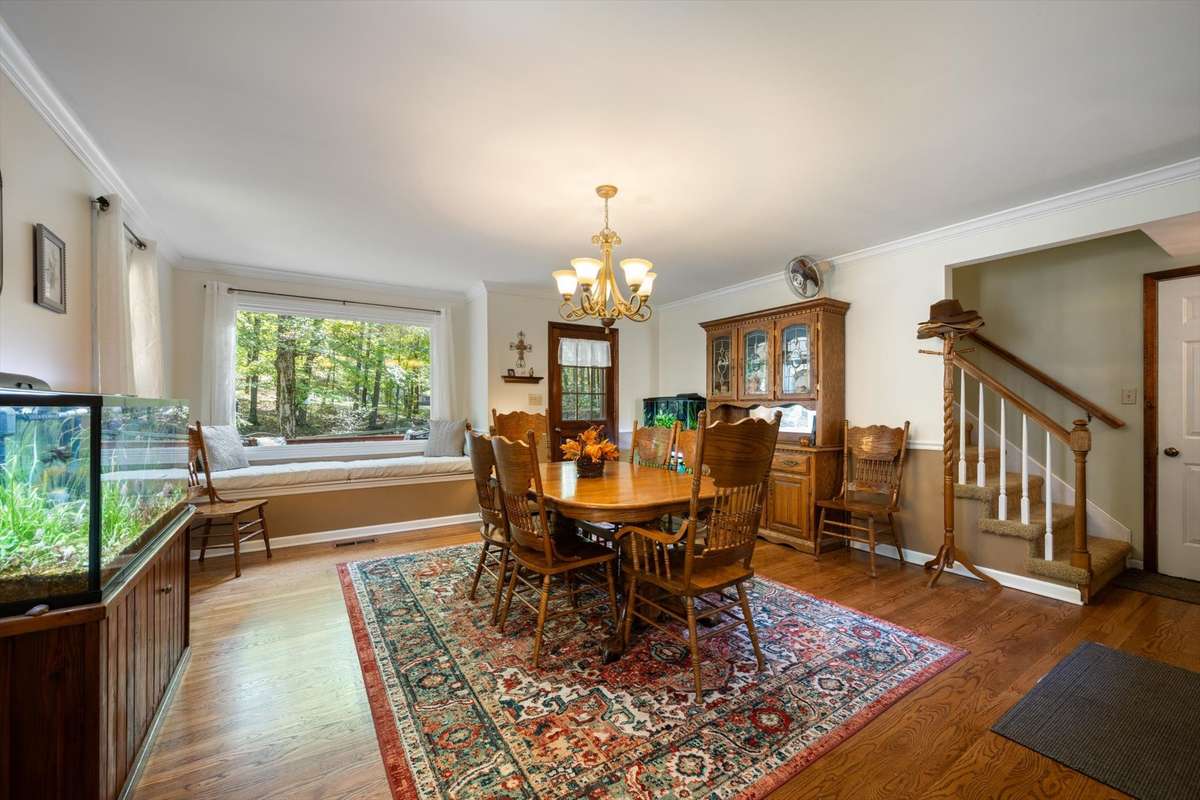 Extra large dining room for all the entertaining! Stairs lead to a bonus room w a full bathroom and 2 walk-in closets and a balcony (being used as a guest suite).