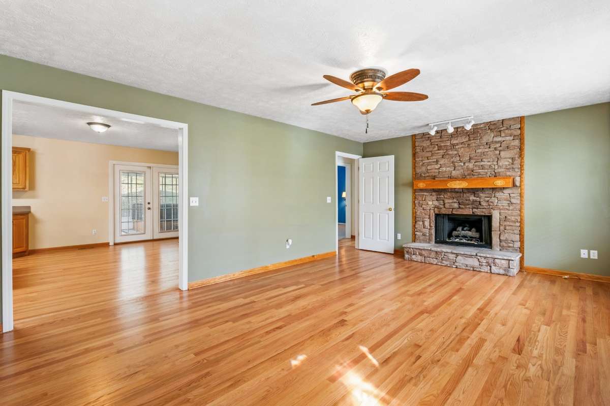 Main level with a hardwood floor and a fireplace in your living room.