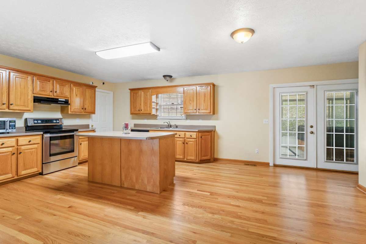 Open kitchen with island and hardwoods