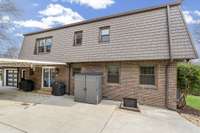 Ideal setup with carport, circle driveway, and extra storage.
