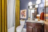 Full bath on the main level serves as the powder room