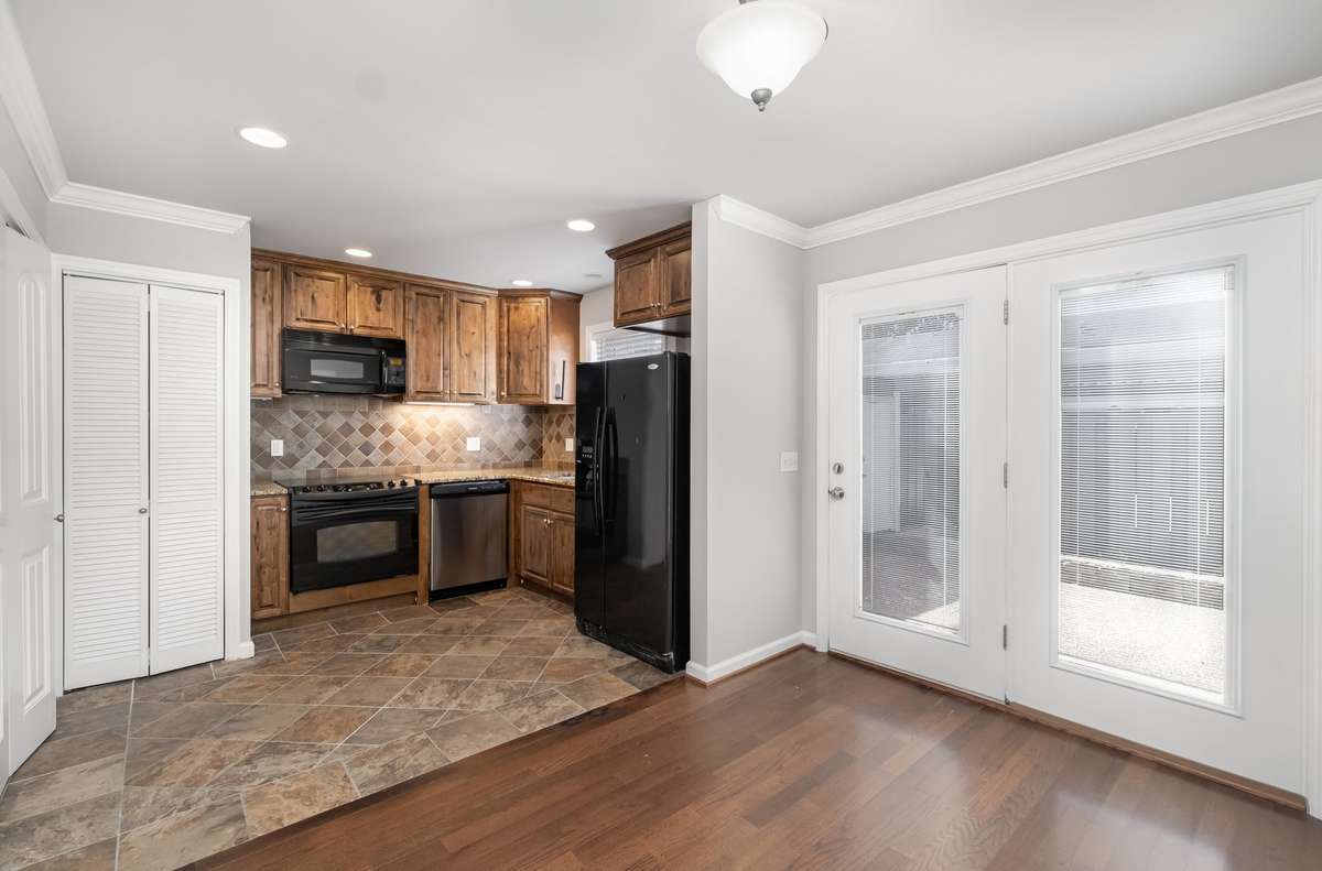 Kitchen boasts beautiful high end cabinets, Granite Counters, Tile Backsplash Stove, Dishwasher, Microwave and Refrigerator all remain.