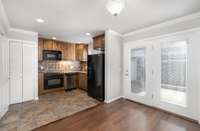 Kitchen boasts beautiful high end cabinets, Granite Counters, Tile Backsplash Stove, Dishwasher, Microwave and Refrigerator all remain.