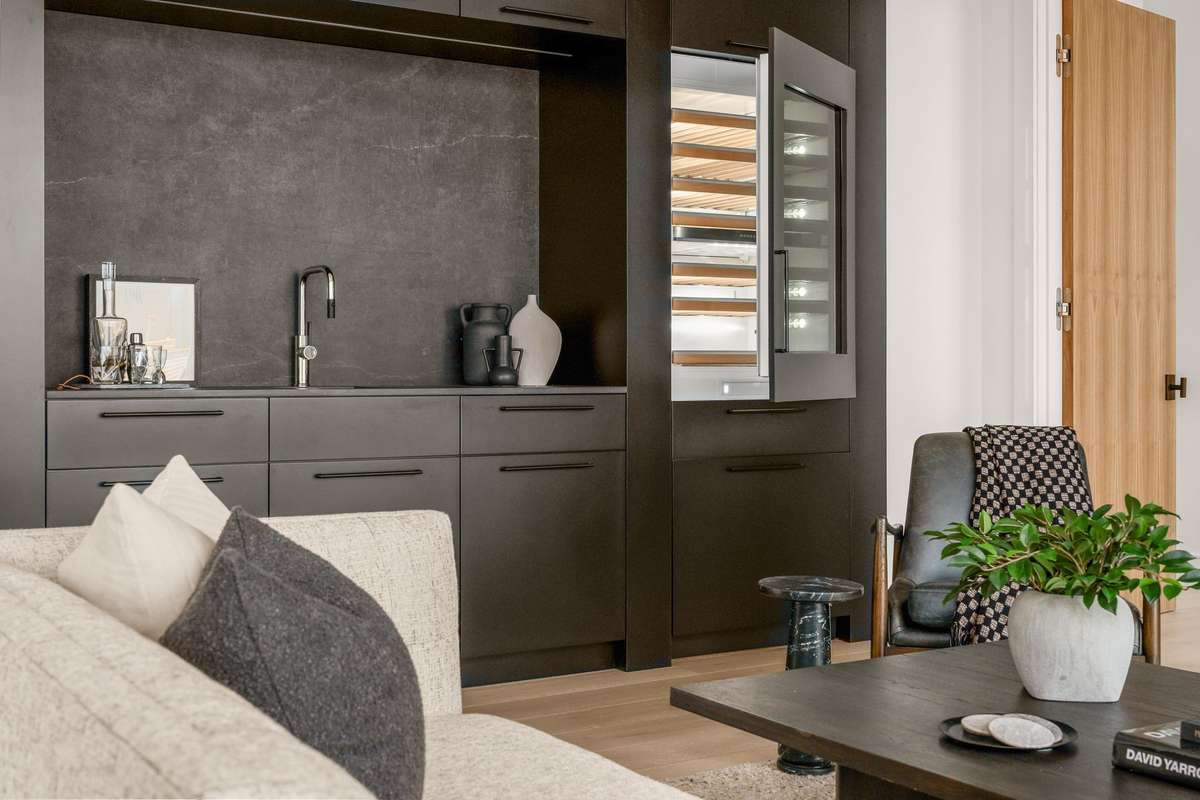 Designer wet bar featuring a beverage fridge and sleek finishes