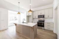 Custom cabinetry with quartz countertops and designer finishes~