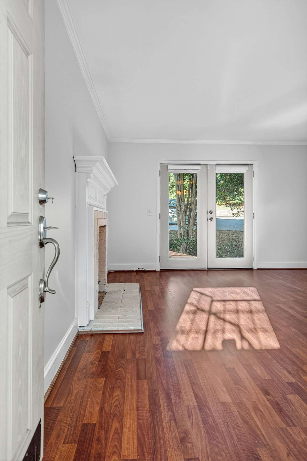 The light filled living room has French doors to a small patio on the back of the building.