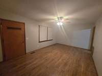 Large Living Room with original hardwood floors. New paint and new blinds.