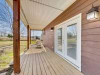 Relaxing back porch ideal for unwinding and enjoying the peaceful setting.