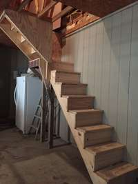 Stairs leading to storage attic- (picture taken during construction of stairs)