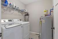 A convenient laundry room is located near the bedroom areas.