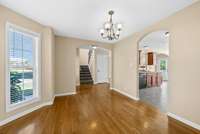 Other side of formal dining area showing how it opens to foyer area and kitchen. Notice the arched openings