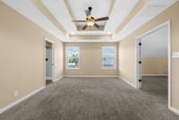 Primary bedroom suite. This room can be used as the bedroom OR a sitting area, OR an office. Door on left leads to the bathroom.  Doors on right lead to the largest room of the primary suite area